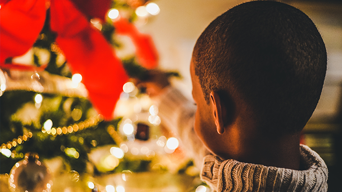 Boy decorating Christmas tree