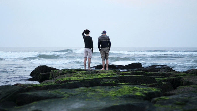 two people looking at the ocean