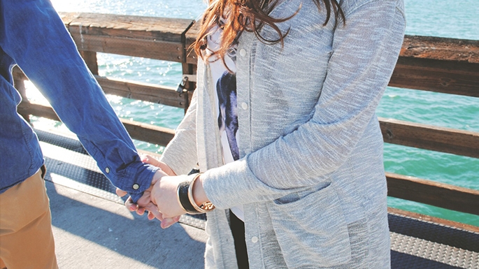 teen couple holding hands